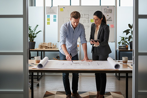 image of business people overlooking blueprints